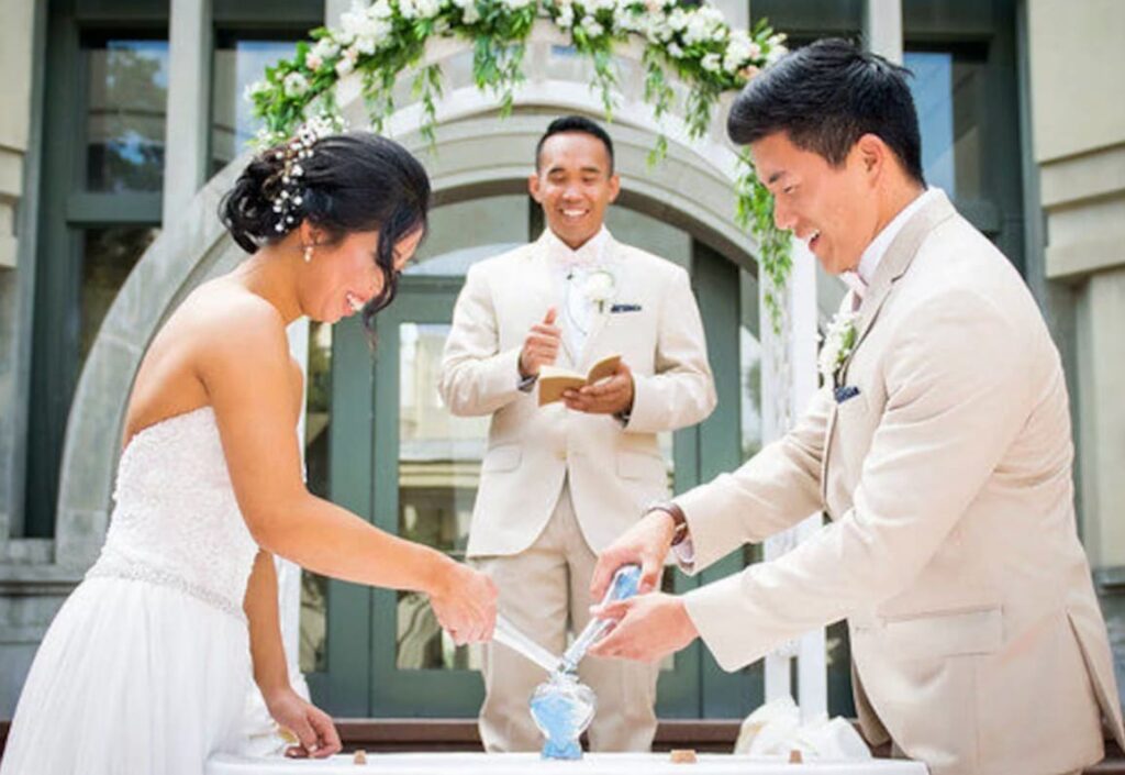 Couple pouring sands in ceremony