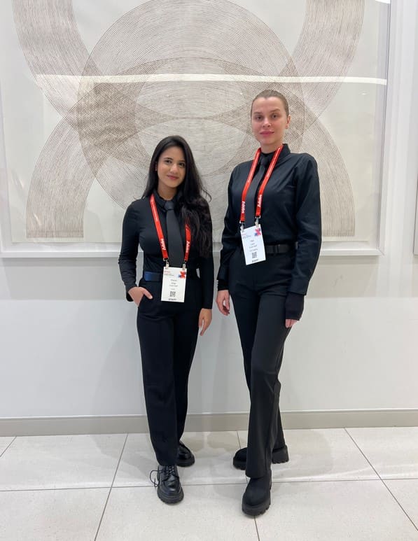 Female registration staff welcoming guests and providing wayfinding assistance at Adobe Experience Makers conference