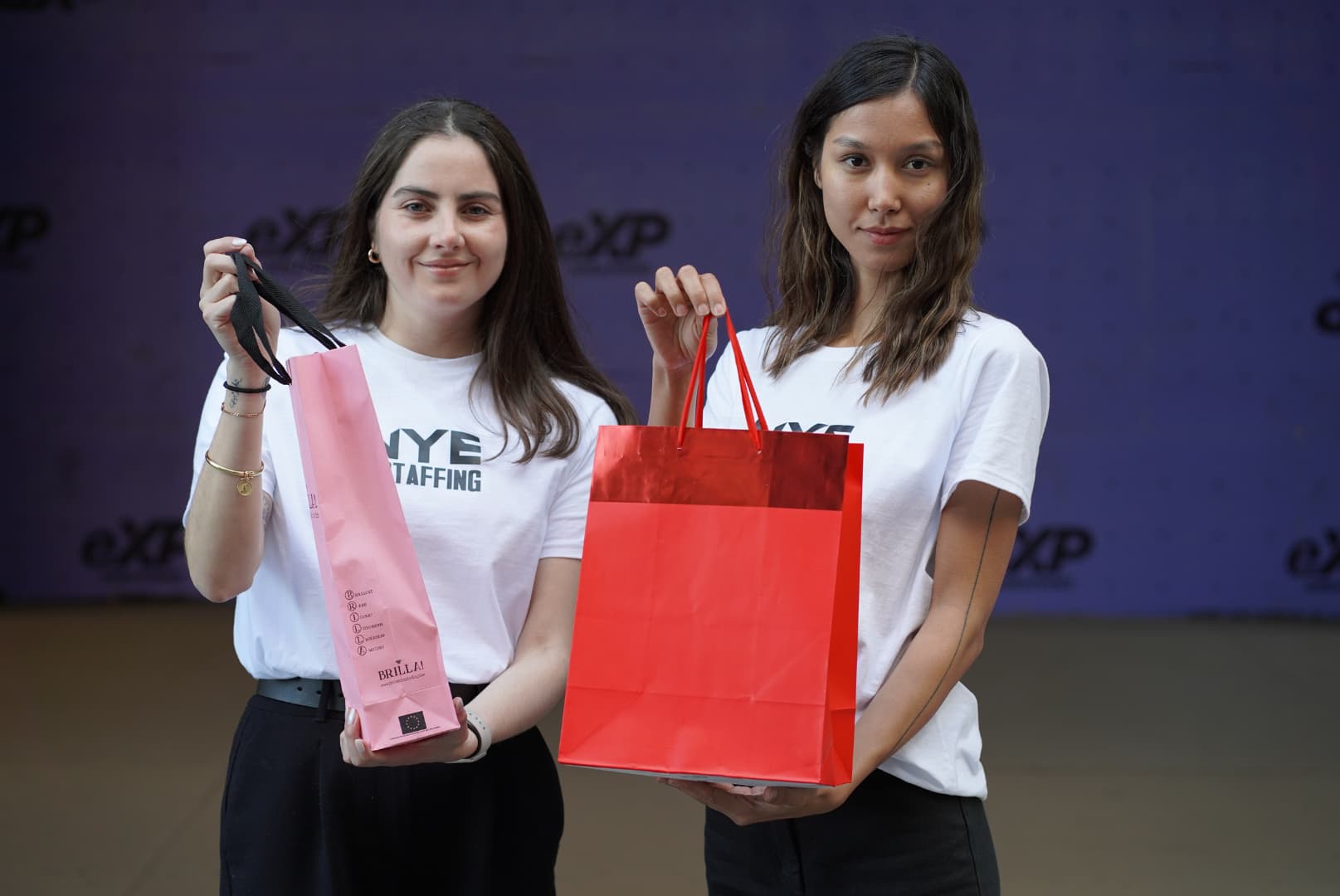 NYE Staffing product demonstrator team showcasing promotional bags during a marketing event in Los Angeles