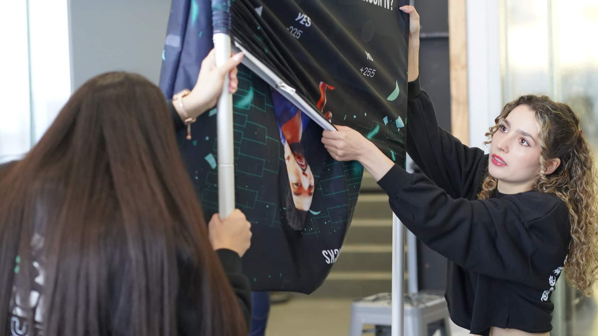 Event staff setting up trade show booth and display structure