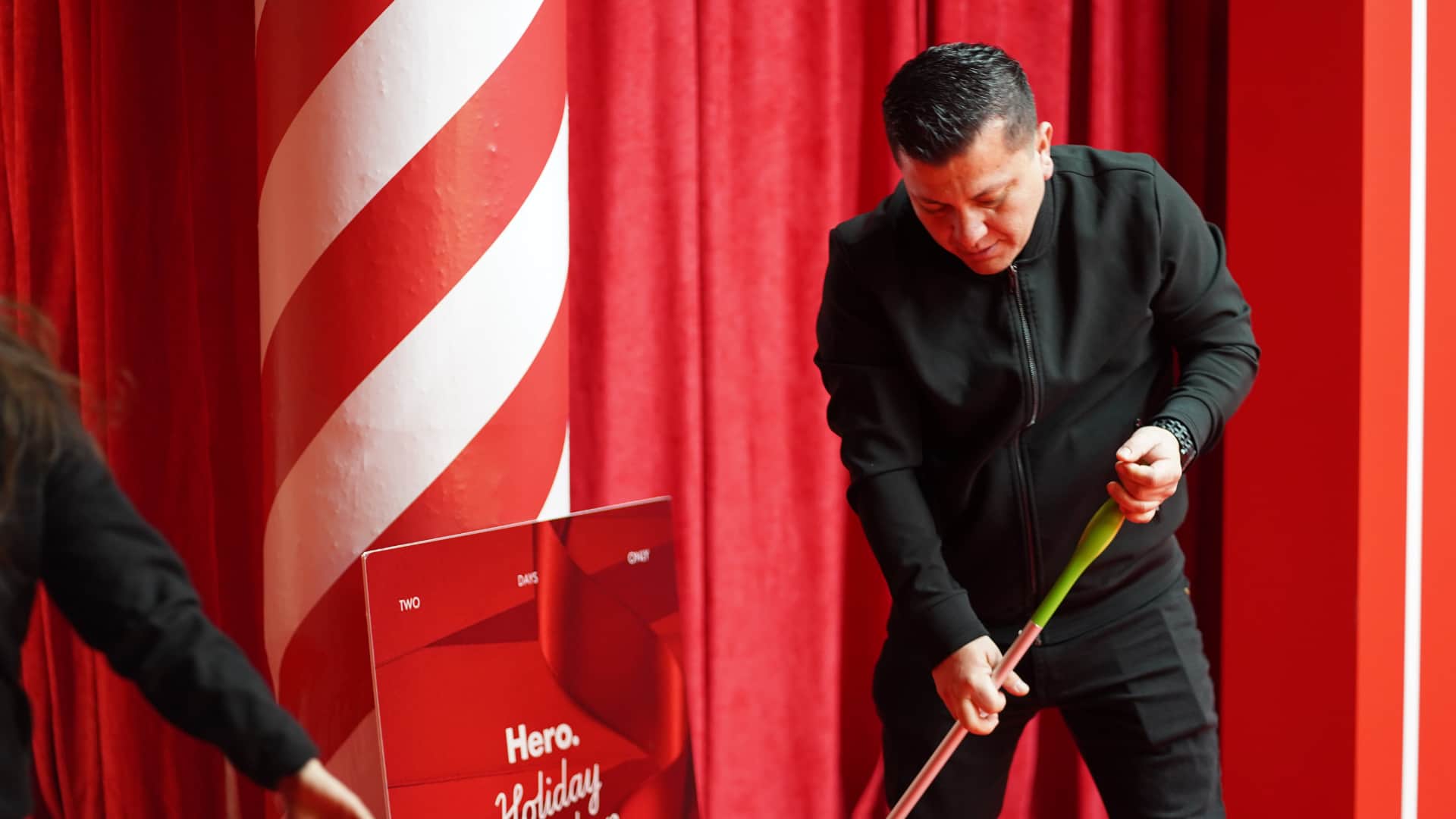 Event cleaning crew member picking up trash and maintaining cleanliness during post event cleanup in Soho