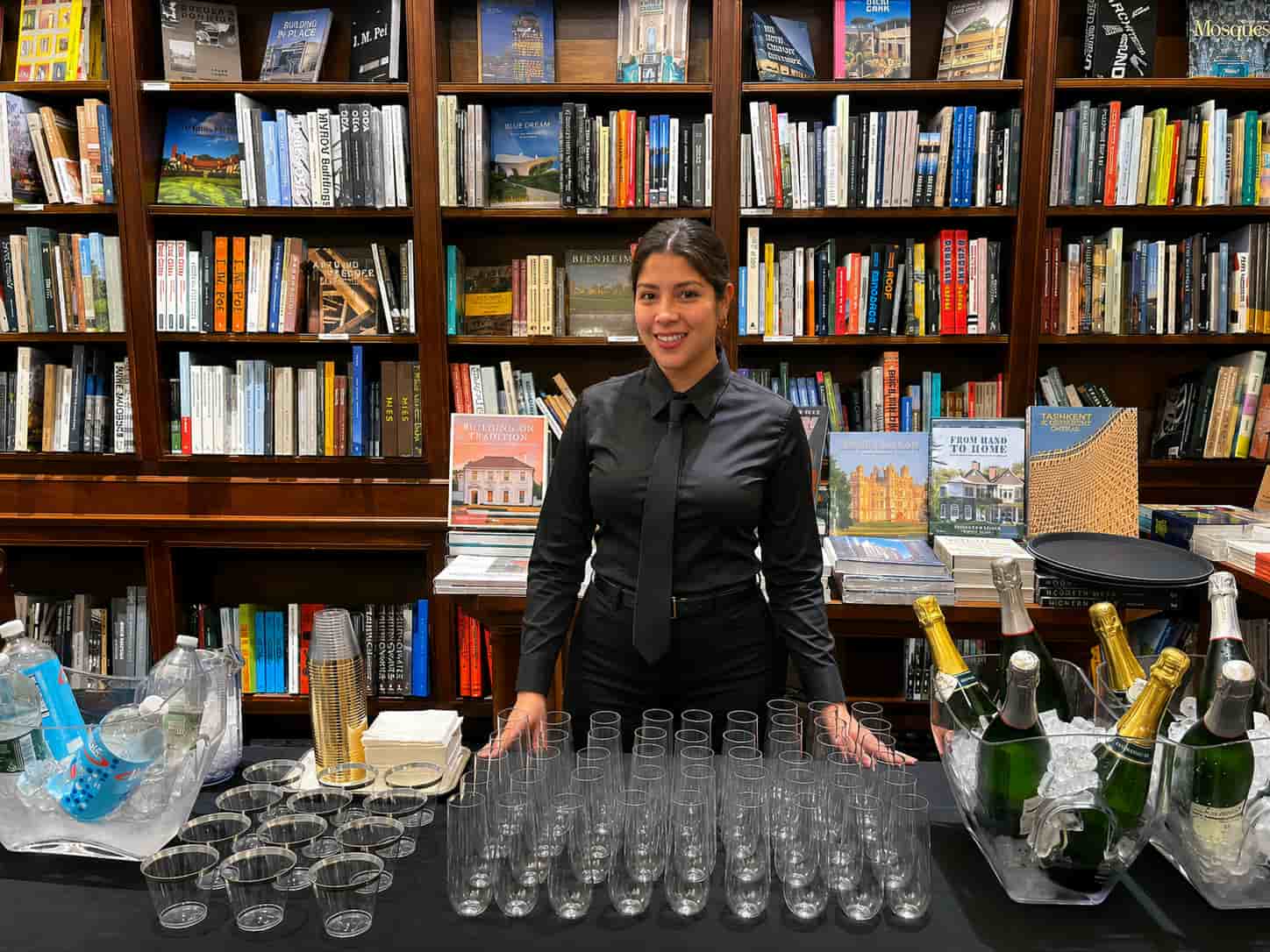 Bartender serving guests and managing beverage station during wedding reception staffing event at elegant library venue in Chicago Illinois